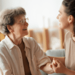 A young woman affectionately talks with an older woman