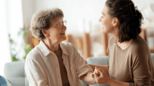A young woman affectionately talks with an older woman