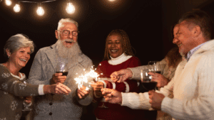 Older adults cheers with glasses of wine and sparklers
