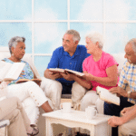 older adults sit in a semi-circle discussing a book